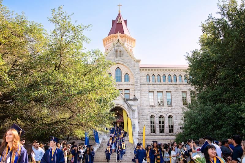 Graduates walk through the Red Doors during the Spring Legacy Walk.