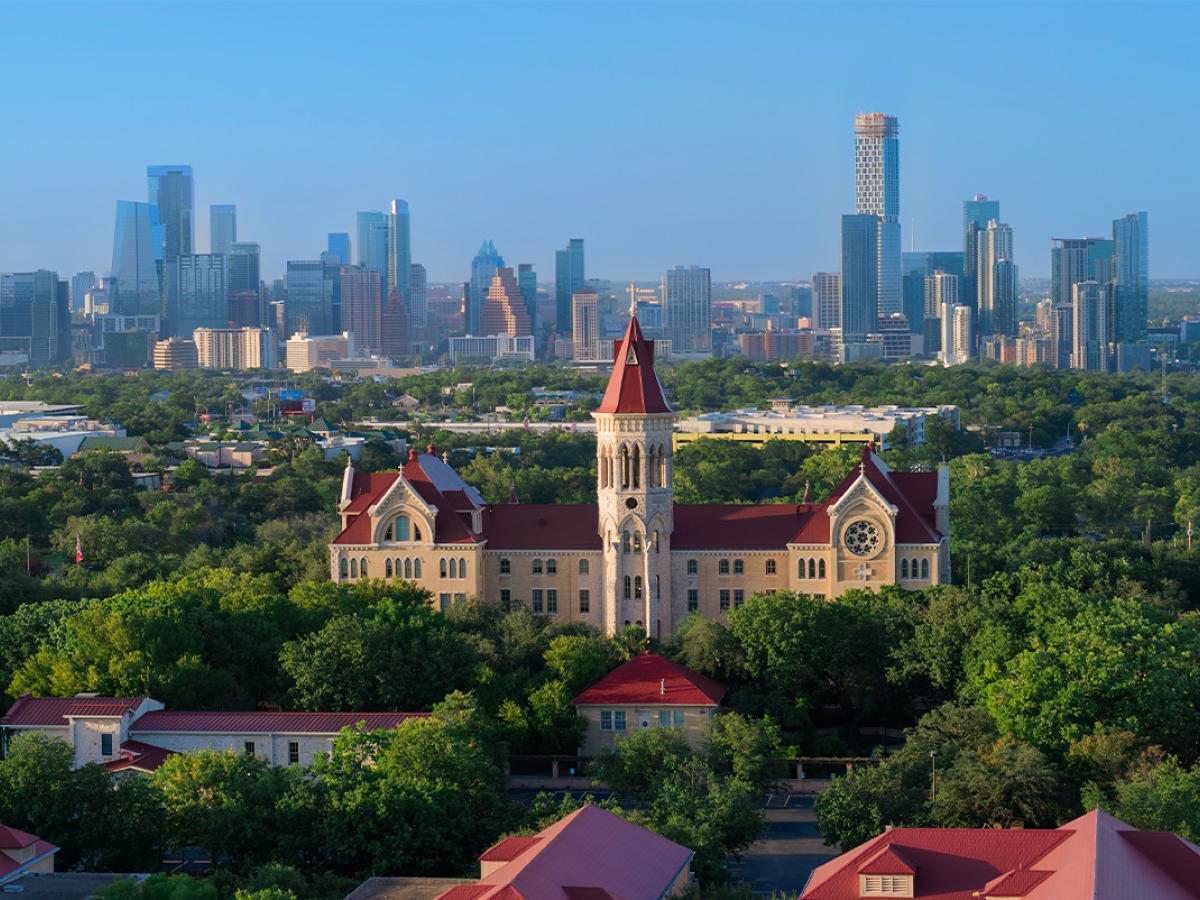 Drone view of Main Building and the Austin skyline.