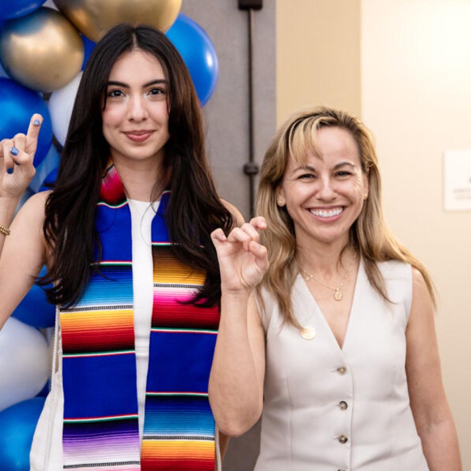 student with president fuentes at latin student graduation
