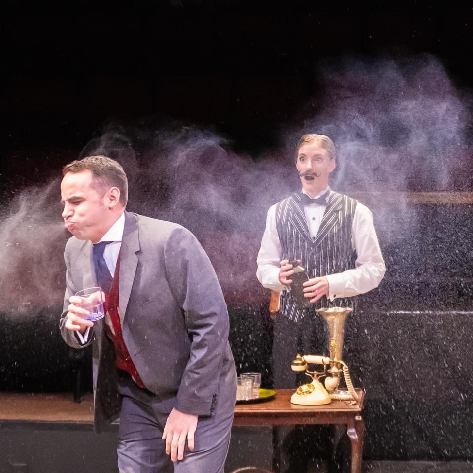 Actor doing a spit take in The Play That Goes Wrong.