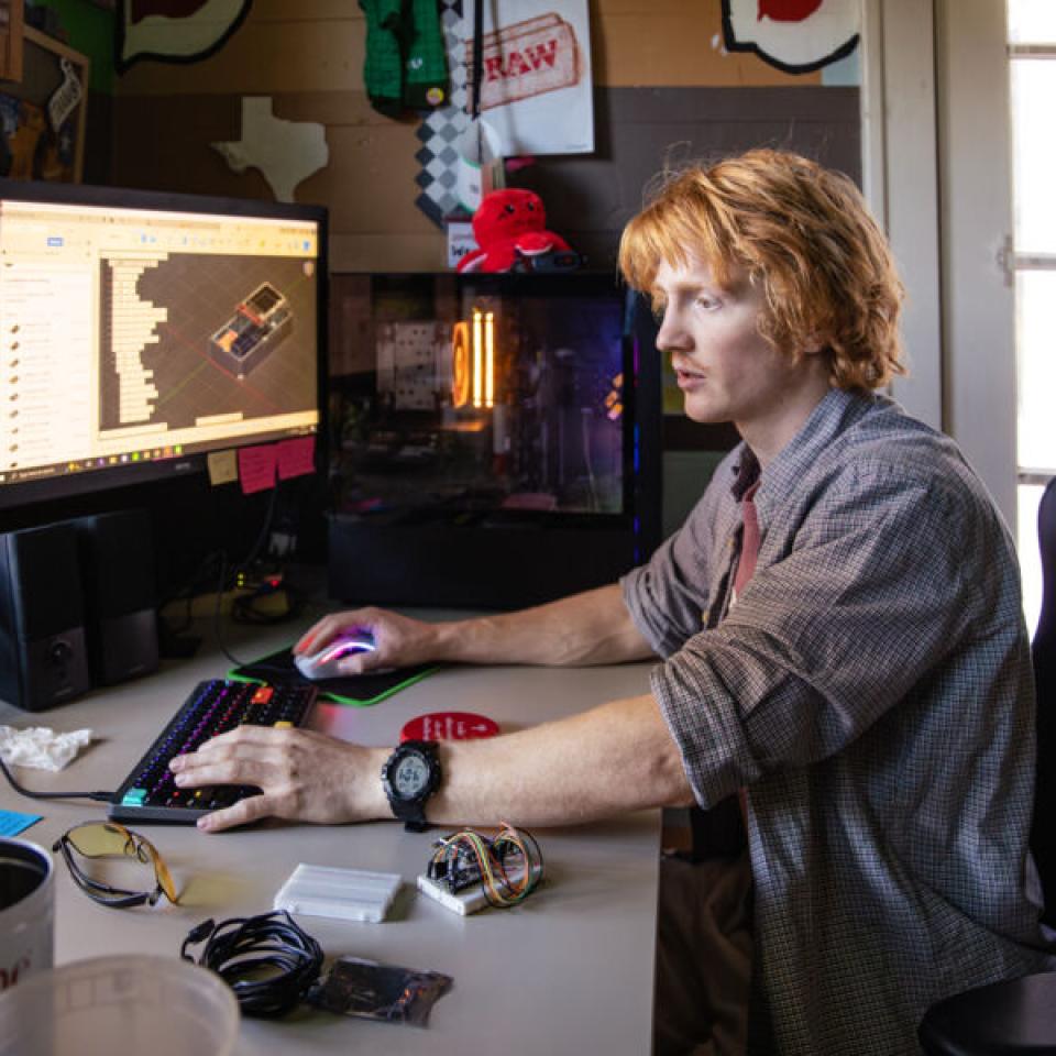 Ethan Burd sits at his desk to work on school projects