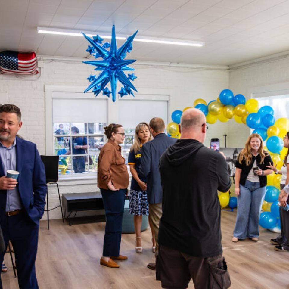 Hilltoppers celebrate the grand opening of the new Carriage House space for the Kozmetsky Center.