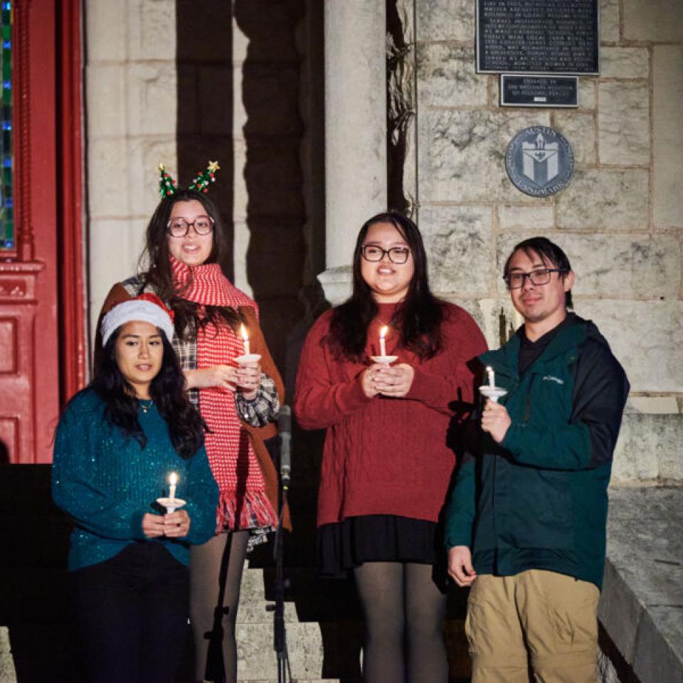 Carolers singing in front of Main Building during the Festival of Lights.