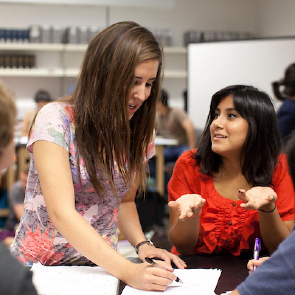 People studying girl in red shirt
