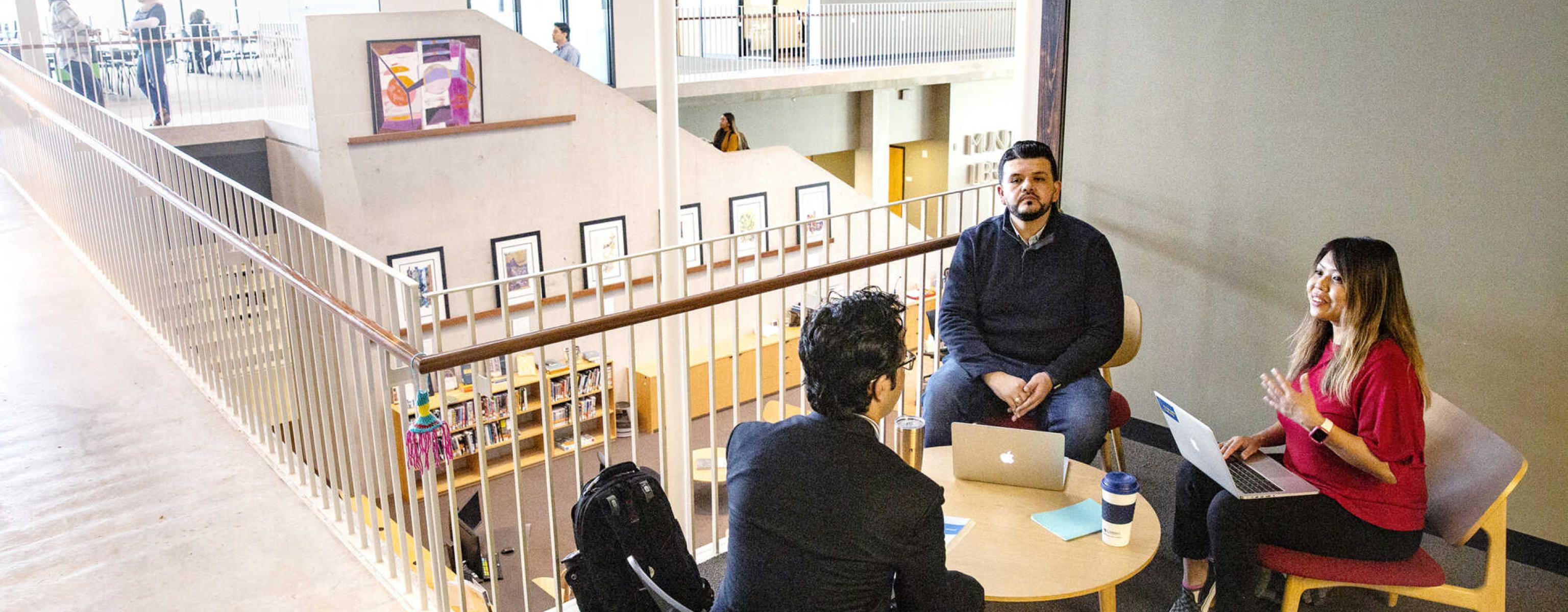 Graduate students meeting in the Munday library about a class project