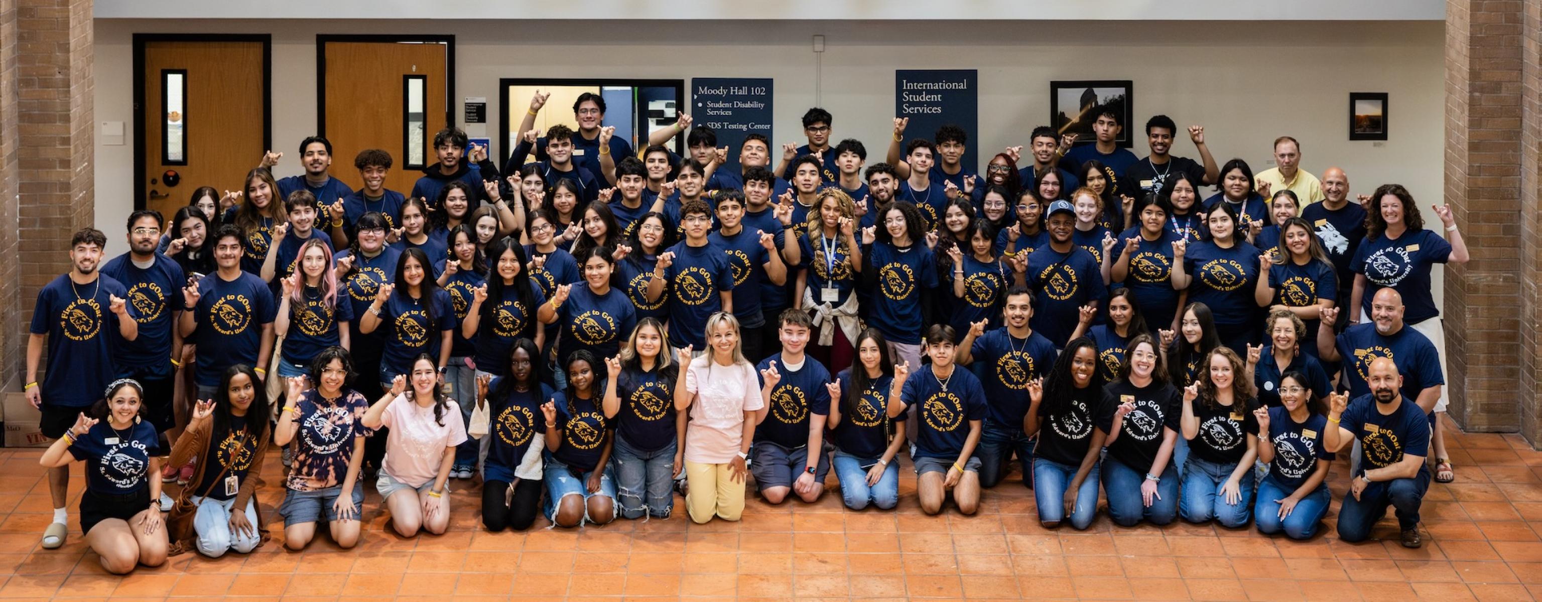 First Generation Student Welcome Event holding up SEU toppers up sign