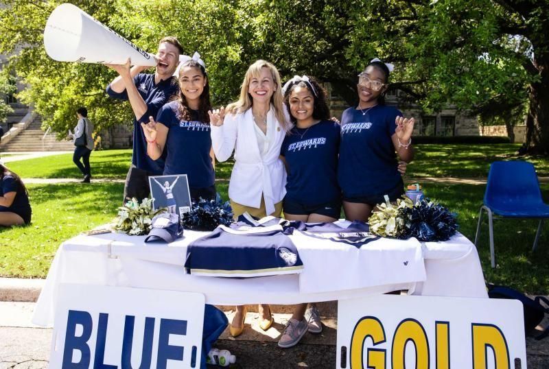President Fuentes and students giving the "Toppers up" at a Blue and Gold event