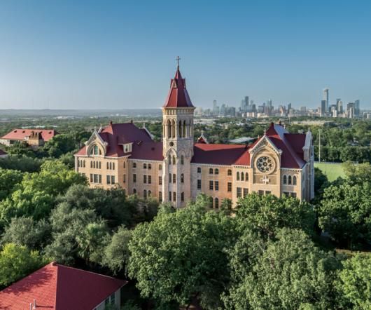 An aerial view of Main Building and the St. Edward's University campus with the downtown Austin skyline in the background