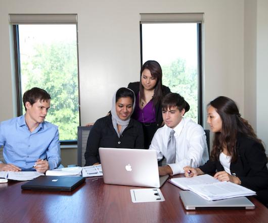 Group of students at laptop accounting