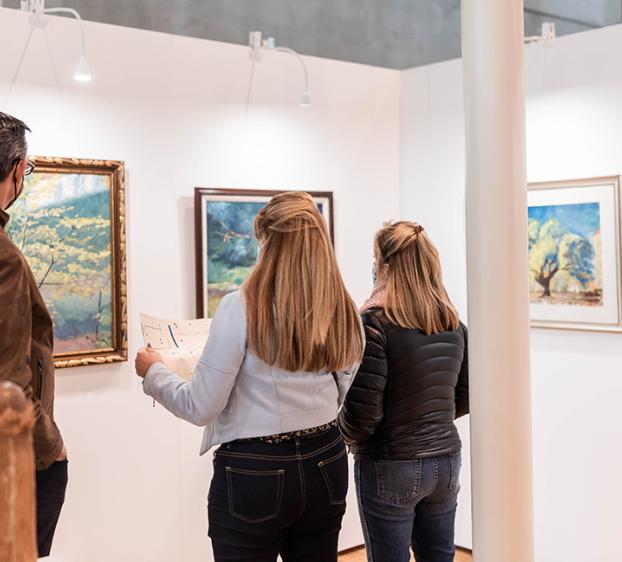 Visitors viewing an art gallery in the Munday Library