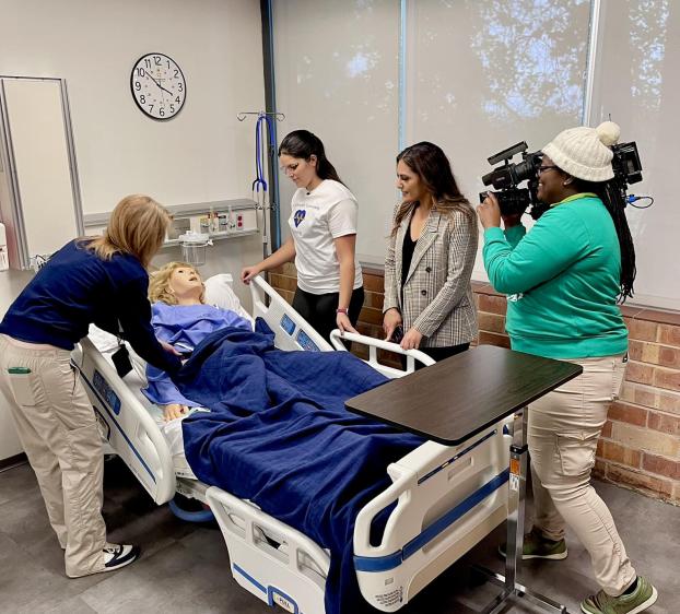 Media crew tours the nursing facilities in Fleck Hall.