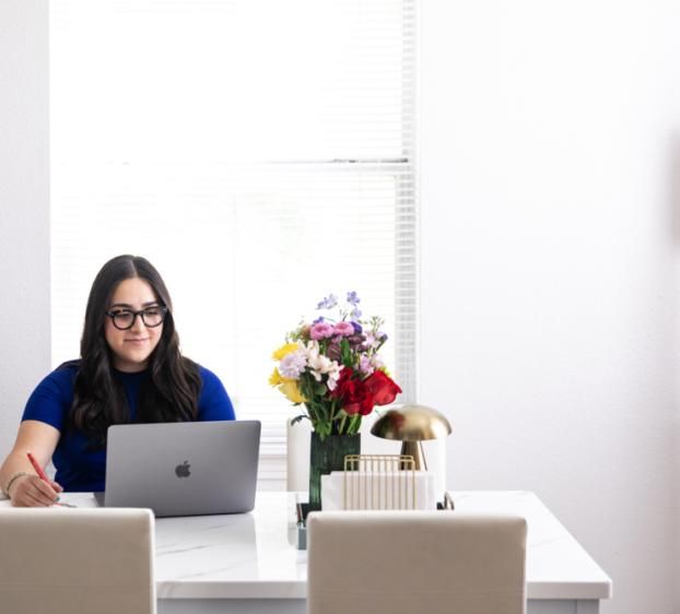 Student studying at desk in university housing dorm room with residential hall amenities at St. Edward’s University.