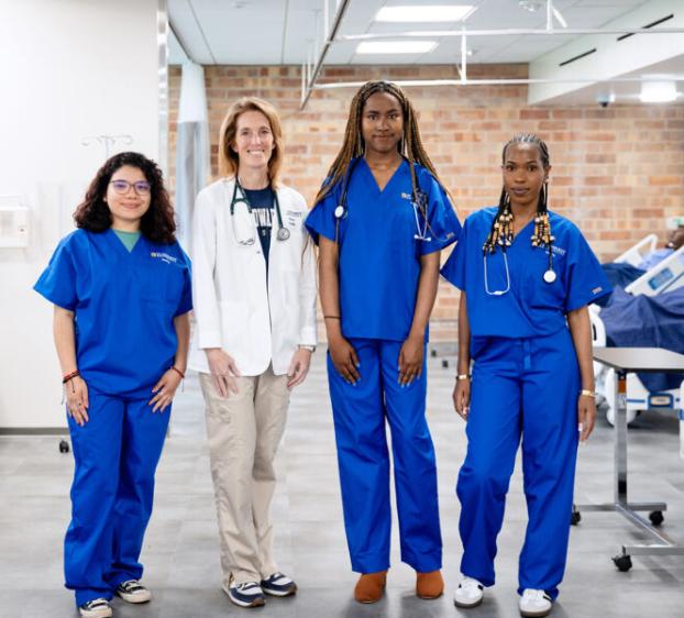 Assistant Professor of Nursing Katy Allen poses for a photo with Nursing students in Fleck Hall.