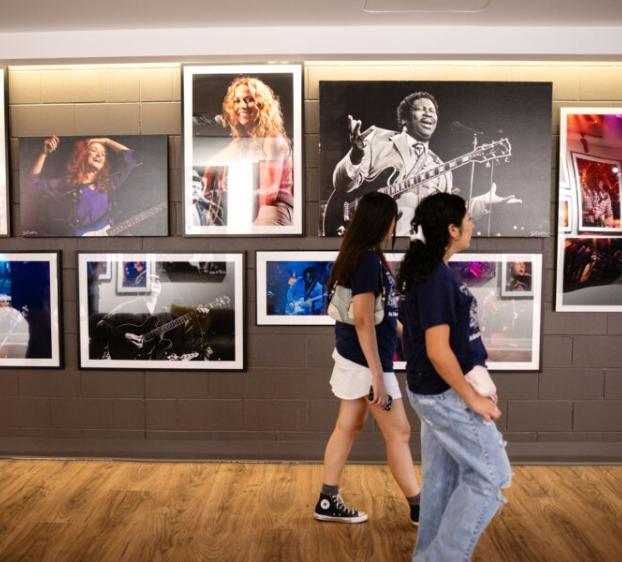 Two students walk passed iconic imagery in ACL Live