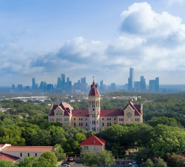 Birds eye view of St. Edward's University and the Austin skyline.