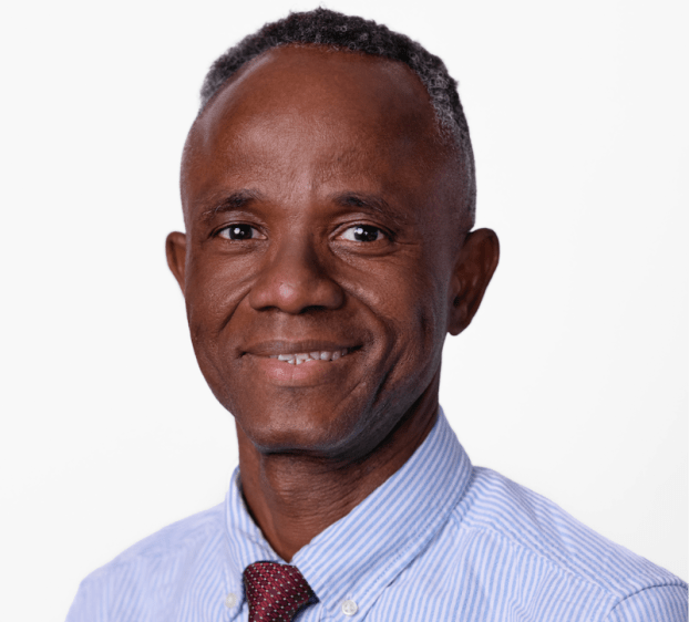 closeup of man smiling wearing a shirt and tie