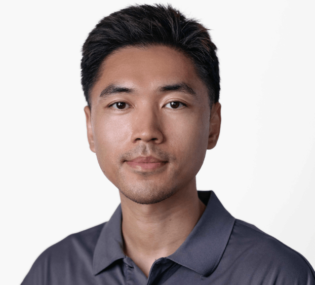 closeup of man with dark hair wearing a polo shirt