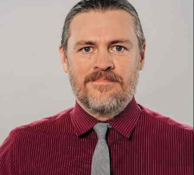 closeup of man with facial hear and a tie
