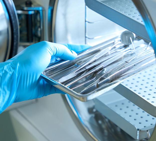 Sterile Processing Technician at work in sterilizing lab