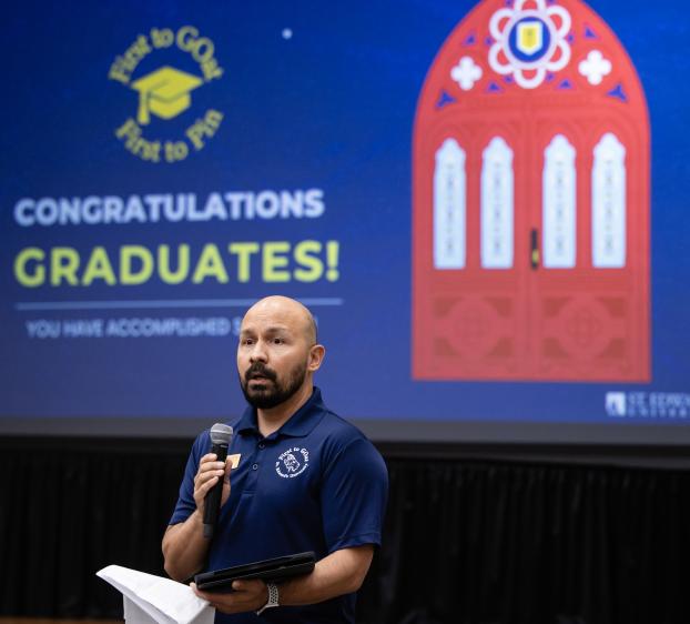Associate Director for First to GOat addressing students at graduation celebration