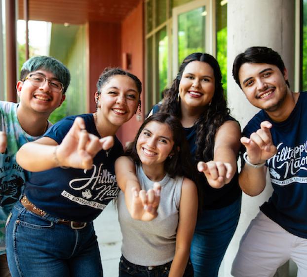 Hilltoppers on campus give the Topper hand sign