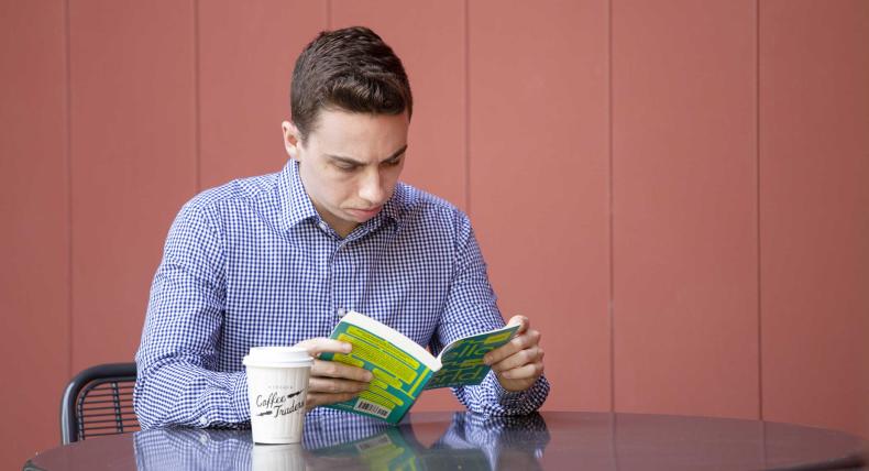 Grad student reading a green book