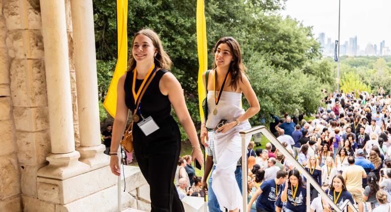 Students walk in through the Red Doors in Main Building for Legacy Walk