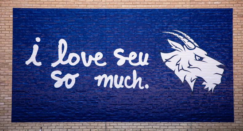 "I Love SEU So Much" mural on building at St. Edward's campus.