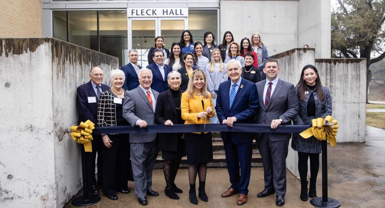 President Montserrat Fuentes and guests attend ribbon cutting ceremony in front of Fleck Hall.