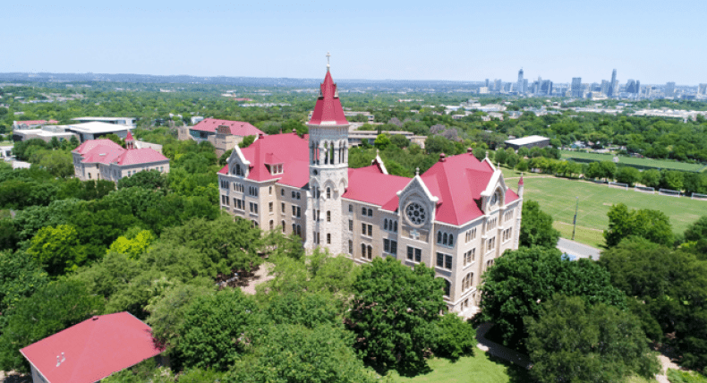 an aerial view of Main Building and the Austin skyline