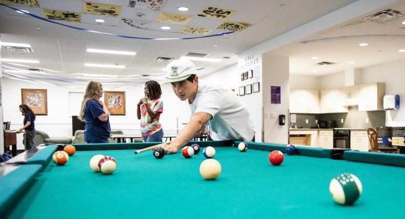 Students playing pool in Basil Moreau Hall.