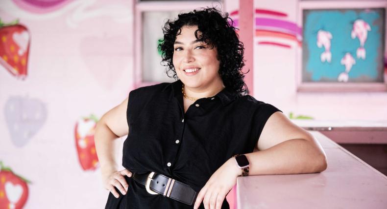 Fabiana Melendez poses in front of a street mural in Austin, Texas