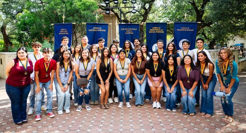 Students posing for a photo at the legacy walk.