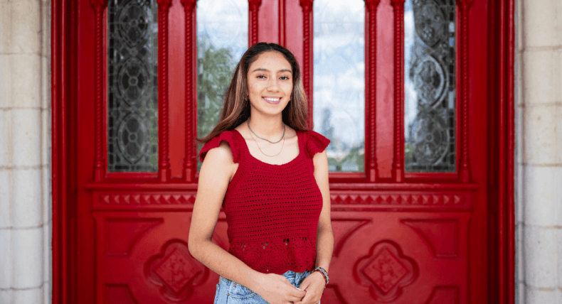 Hailee Alvarez poses in front of Main Building