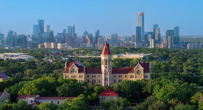 Drone view of Main Building and the Austin skyline.