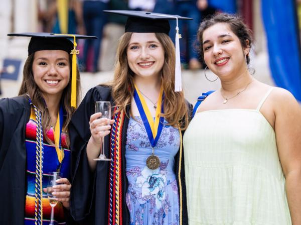 3 students celebrating after graduation ceremony 