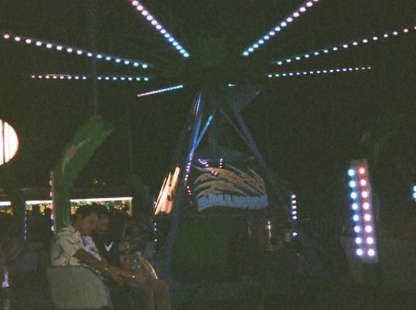 Students ride a ride at night at Hillfest.