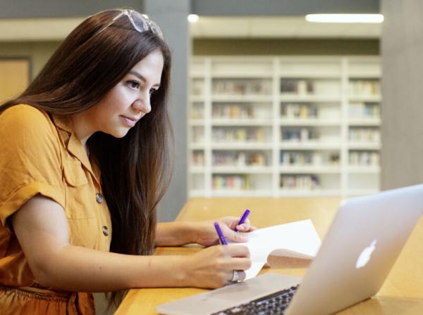 Student writes an essay in the Munday Library.