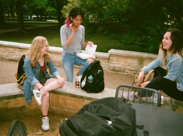 Students hang out behind Main Building chatting