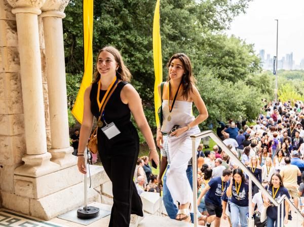 Students walk in through the Red Doors in Main Building for Legacy Walk