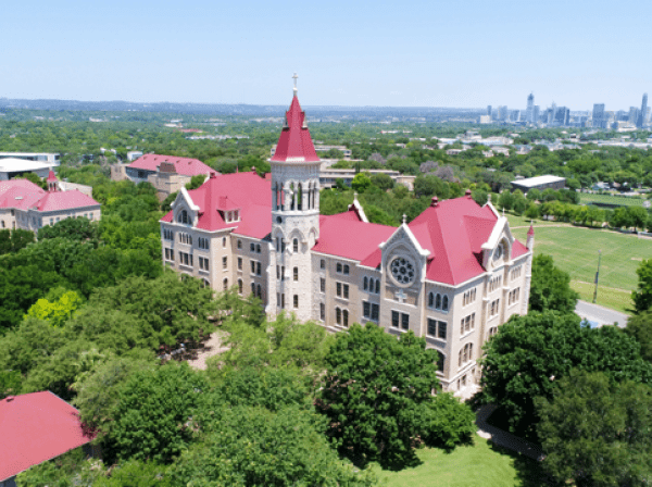 an aerial view of Main Building and the Austin skyline