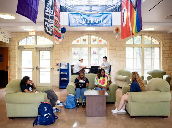 Students sitting in the lobby of Basil Moreau Hall.