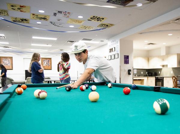 Students playing pool in Basil Moreau Hall.