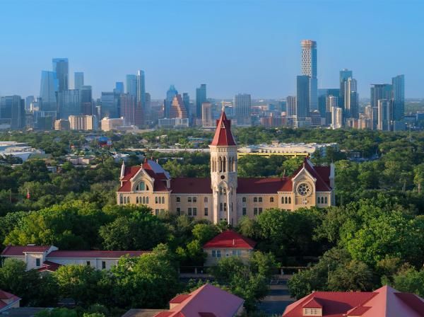 Drone view of Main Building and the Austin skyline.