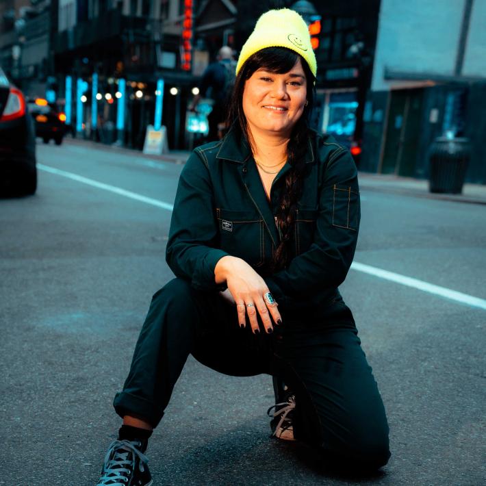 Deneice O'Connor kneeling in the street