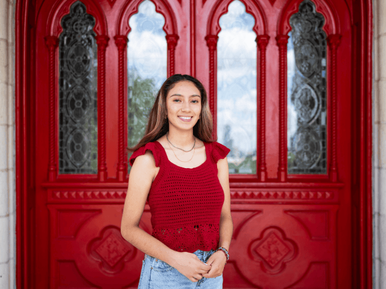 Hailee Alvarez poses in front of Main Building