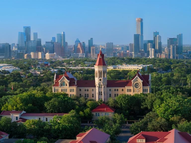 Drone view of Main Building and the Austin skyline.