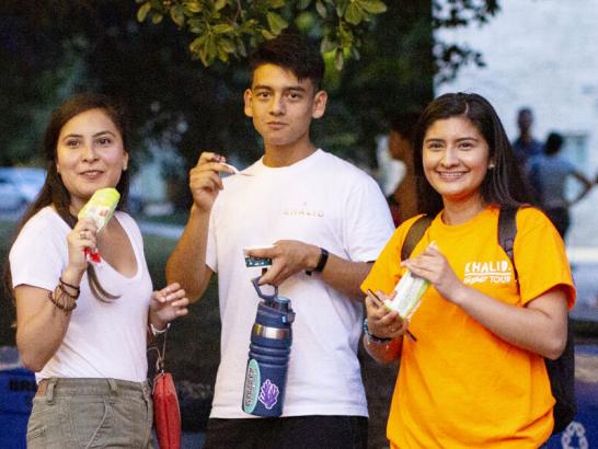 Students enjoying a snack at the block party