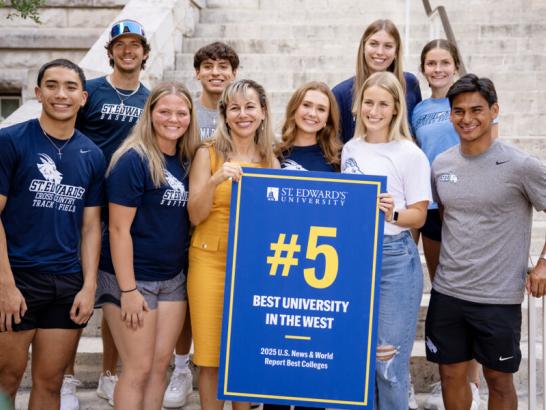 President Fuentes posing with the #5 poster and students