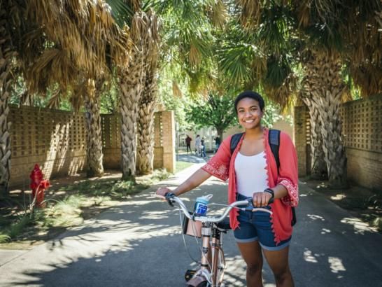 Student Jasmine Adgerson with her bike on campus